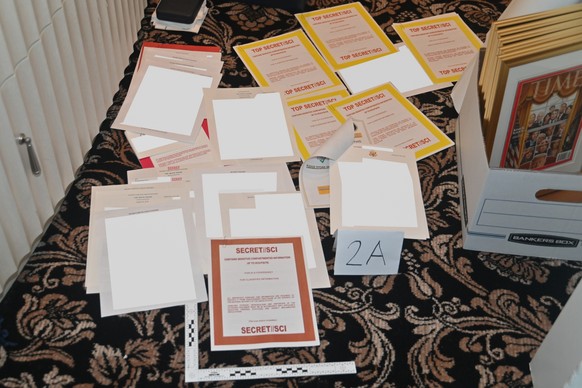 FILE - This image in a Justice Department court file on Aug. 30, 2022, and partially redacted by the source, shows a photo of documents seized during the Aug. 8, 2022 FBI search...