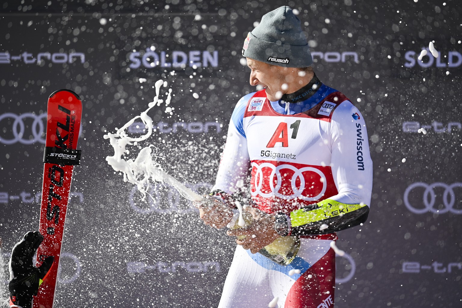 epa09543248 Marco Odermatt of Switzerland celebrates on the podium after winning the men&#039;s Giant Slalom at the FIS Alpine Skiing World Cup season opener on the Rettenbach glacier in Soelden, Aust ...
