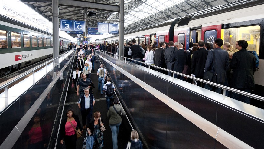 Des pendulaires attendent un train a la gare de Lausanne, ce mercredi matin 13 juillet 2011. (KEYSTONE/Dominic Favre)