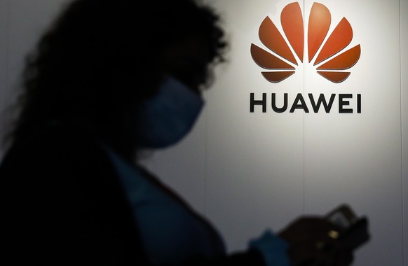epa09678203 A woman using smartphone at the Huawei Customer Experience Centre where 5G technology devices are displayed in Kuala Lumpur, Malaysia, 11 January 2022. Huawei Malaysia signed a memorandum  ...