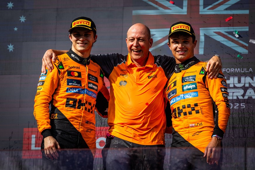 F1 HUNGARIAN GRAND PRIX RACE Lando Norris of Great Britain and McLaren and Oscar Piastri of Australia and McLaren and Mark Ingham, Head of Design at McLaren celebrate on podium with a champagne after  ...