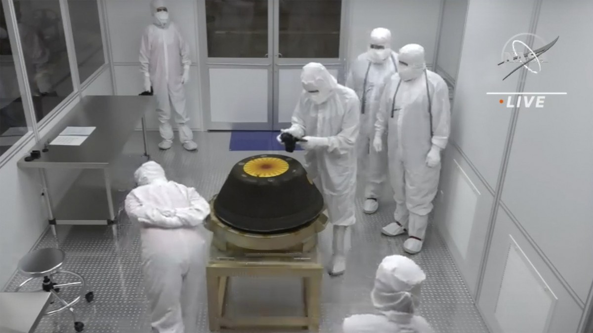 In this image from video provided by NASA, technicians in a clean room examine the sample return capsule from NASA's Osiris-Rex mission after it landed at the Department of Defense's Utah Te ...