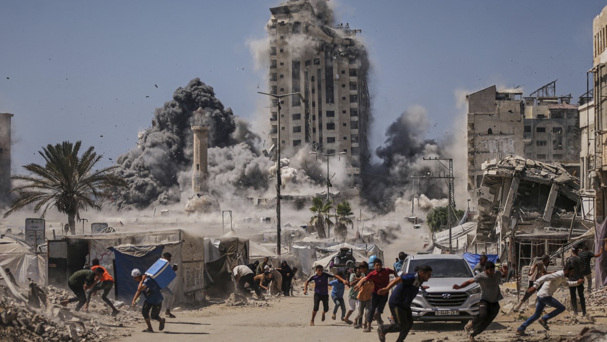 FILE - Palestinians run for cover during an Israeli airstrike on a high-rise building in Gaza City, Friday, Sept. 5, 2025, after the Israeli army issued a warning. (AP Photo/Yousef Al Zanoun, File)
UN ...