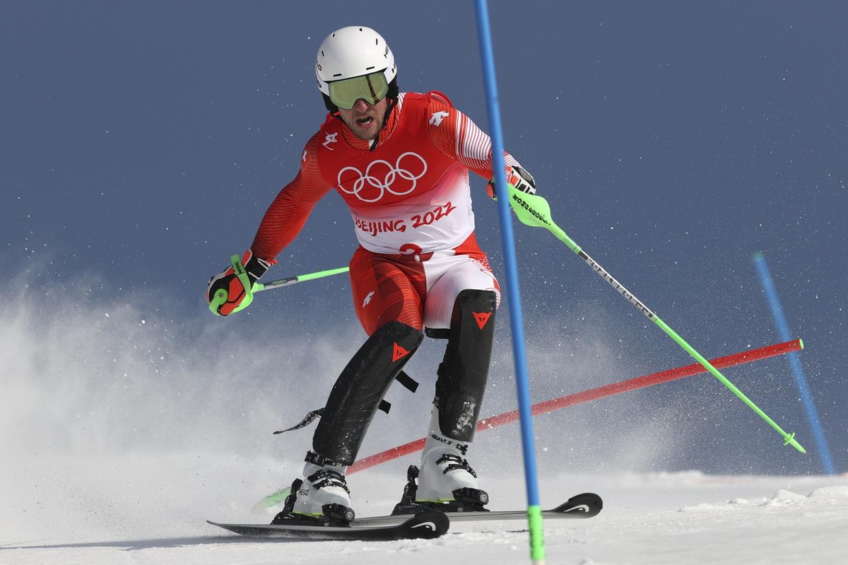 Justin Murisier, of Switzerland passes a gate during the slalom part of the men's combined at the 2022 Winter Olympics, Thursday, Feb. 10, 2022, in the Yanqing district of Beijing. (AP Photo/Ales ...