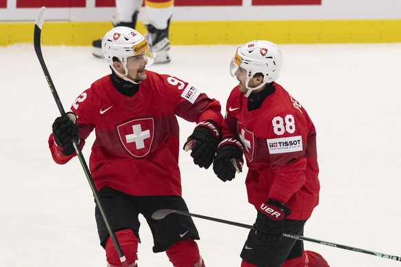 Switzerland's Gaetan Haas, left, and Switzerland's Christoph Bertschy icelebrate their goal to 1-0 during the Ice Hockey World Championship quarter final match between Switzerland and German ...