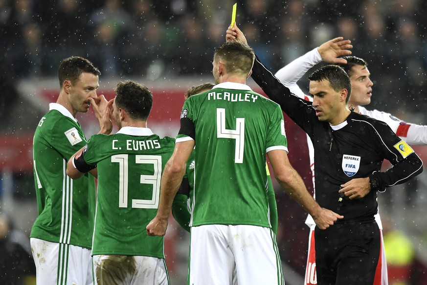 From left to right, Northern Ireland&#039;s defender Jonny Evans, Northern Ireland&#039;s midfielder Corry Evans and Northern Ireland&#039;s defender Gareth McAuley, react next to Romania&#039;s refer ...