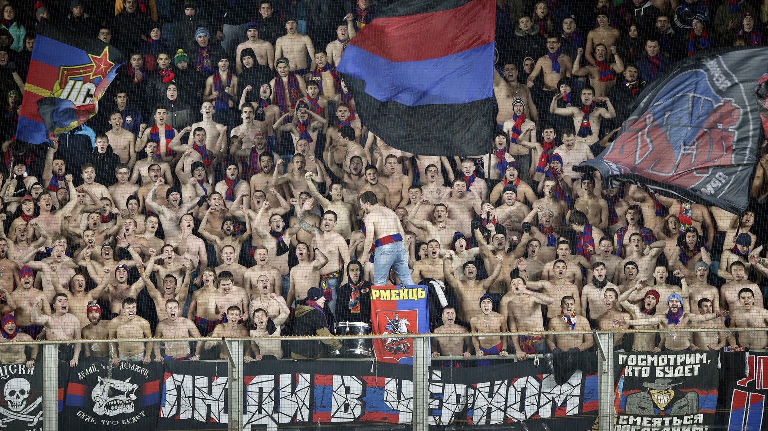 FILE - In this photo taken on Wednesday, Oct. 21, 2015, CSKA Moscow&#039;s fans, most of them without their shirts on, cheer for their team in freezing temperatures, during the Champions League Group  ...