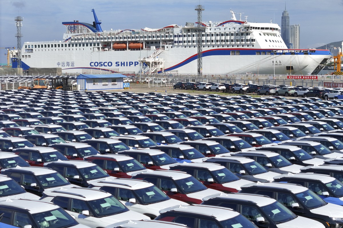 New cars wait to be transported on a dockyard in Yantai in eastern China's Shandong province on Sunday, Aug. 6, 2023. Customs data show China's exports plunged 14.5% in July compared with a  ...