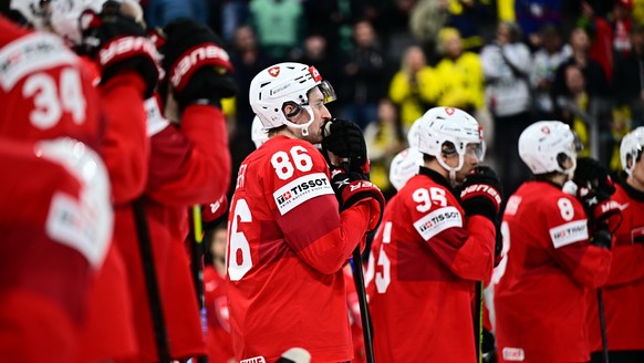 epa12135801 Switzerland's Janis Moser (#86) and the rest of the Swiss players react after losing the IIHF Ice Hockey World Championship final match between Switzerland and the USA at Avicii Arena ...