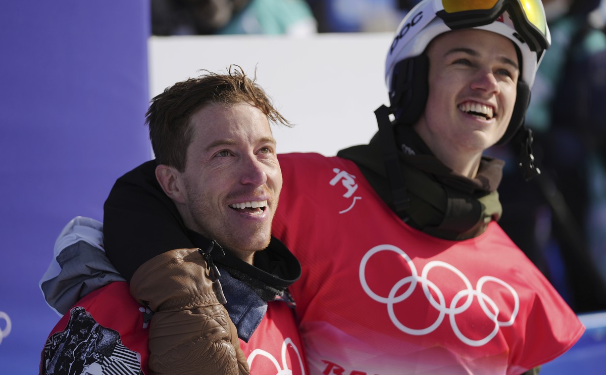 United States' Shaun White, left, and Switzerland's Jan Scherrer watches during the men's halfpipe finals at the 2022 Winter Olympics, Friday, Feb. 11, 2022, in Zhangjiakou, China. (AP  ...