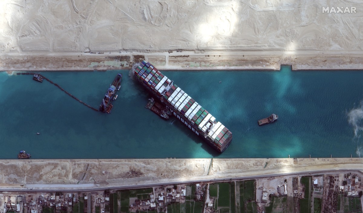This satellite image from Maxar Technologies shows the cargo ship MV Ever Given stuck in the Suez Canal near Suez, Egypt, Sunday, March 28, 2021. Two additional tugboats sped Sunday to Egypt's Su ...