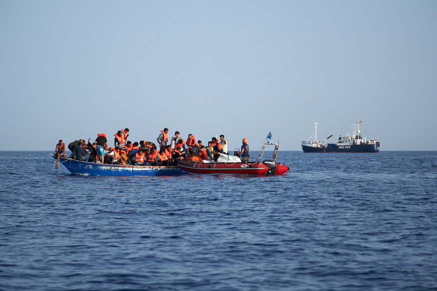 epa07704799 A handout photo made available by German civil sea rescue organisation sea-eye shows a boat carrying migrants (L) and a rescue boat of sea-eye, in the Mediterranean Sea, 08 July 2019 (issu ...