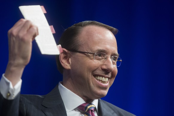 epa06705321 US Deputy Attorney General Rod Rosenstein holds a copy of the US Constitution while participating in a discussion on Law Day, at the Newseum in Washington, DC, USA, 01 May 2018. EPA/MICHAE ...