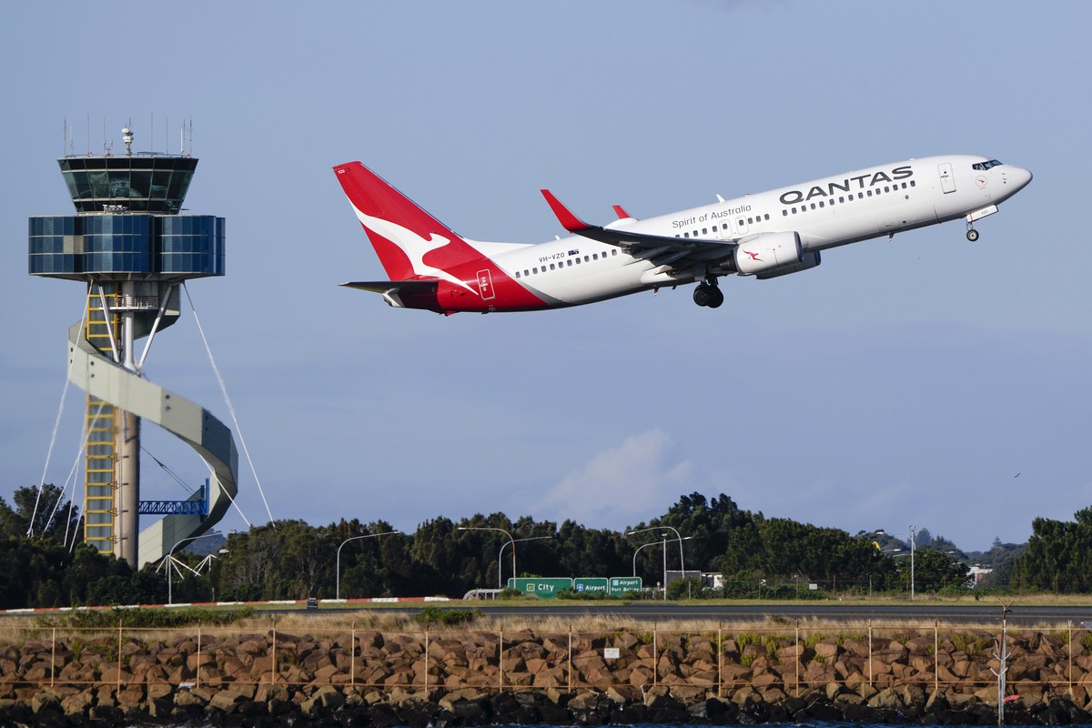 FILE - A Qantas Boeing 737 passenger plane takes off from Sydney Airport, Australia, on Sept. 5, 2022. Qantas Airways agreed to pay 120 million Australian dollars ($79 million) in compensation and fin ...