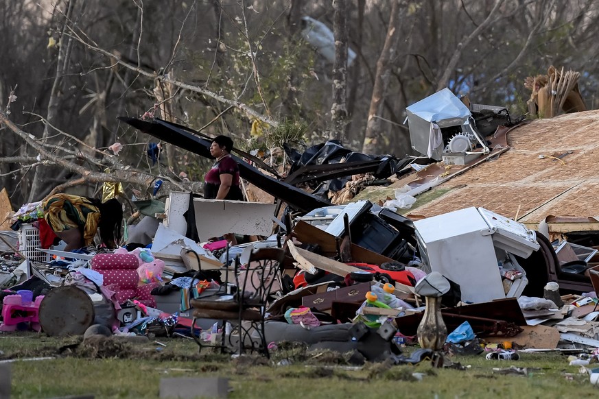 epa10543681 Residents look through a destroyed home the day after a tornado in the small rural community of Wren, Mississippi, USA, 25 March 2023. At least 25 people have been killed after an overnigh ...