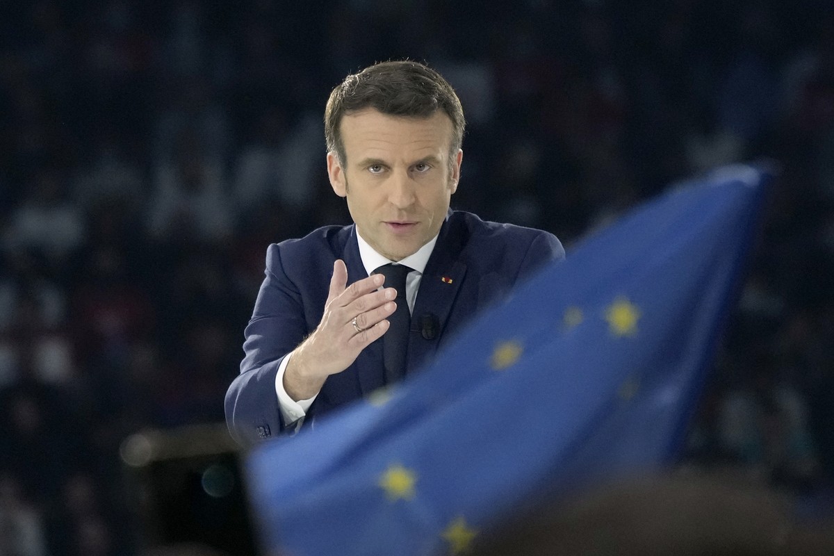 French President Emmanuel Macron and centrist candidate for reelection gestures as he delivers his speech during a meeting in Paris, Saturday, April 2, 2022. France's first round of the president ...