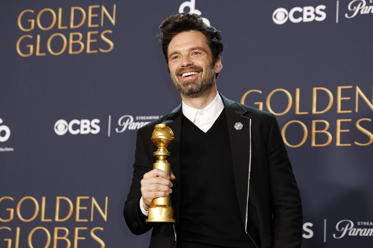 epa11808171 Roman ian-American actor Sebastian Stan poses in the press room with the award for best performance by a male actor in a motion picture - musical or comedy for 'A Different Man'  ...