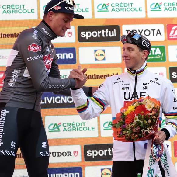 epa11981563 Dutch rider Mathieu Van Der Poel of the team Alpecin-Deceuninck celebrates on the podium with third placed Tadej Pogacar after winning the Milano to Sanremo one-day cycling classic race in ...