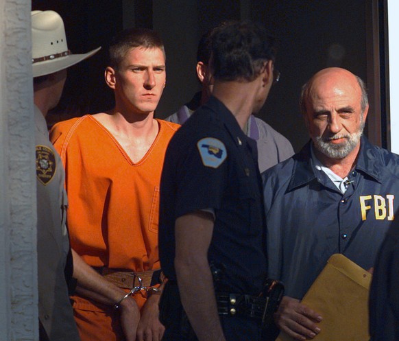 FILE - In this April 21, 1995 file photo, Timothy James McVeigh is led out of the Noble County Courthouse by state and federal law enforcement officials in Perry, Okla., after being identified as a su ...