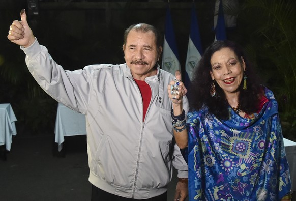 Nicaragua&#039;s President Daniel Ortega and his wife, vice presidential candidate Rosario Murillo show their marked thumbs after voting at a polling station near a his home in Managua, Nicaragua, Sun ...