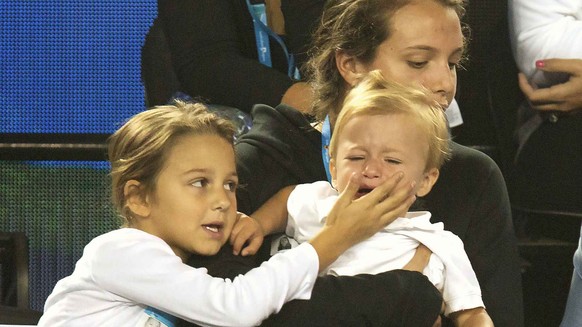 Mirka Federer (C, top), wife of Switzerland&#039;s Roger Federer, looks at her daughter comfort her son as they attend Kids Tennis Day at Melbourne Park, Australia, in this January 16, 2016 handout ph ...