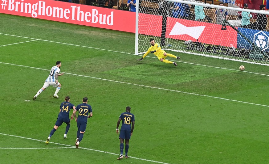 epa10372265 Lionel Messi (L) of Argentina scores the 1-0 from the penalty spot against goalkeeper Hugo Lloris of France during the FIFA World Cup 2022 Final between Argentina and France at Lusail stad ...