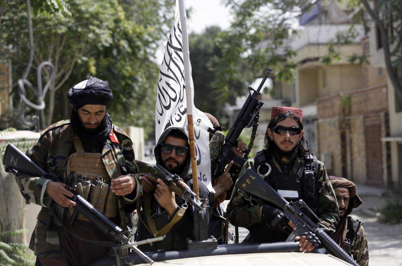 Taliban fighters display their flag on patrol in Kabul, Afghanistan, Thursday, Aug. 19, 2021. The Taliban celebrated Afghanistan&#039;s Independence Day on Thursday by declaring they beat the United S ...