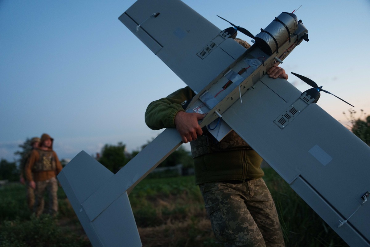 A Ukrainian serviceman of K-2 brigade of the Unmanned Systems Forces carries a midrange drone on takeoff position before flying towards Russian positions at the frontline in Donetsk region, Ukraine, M ...