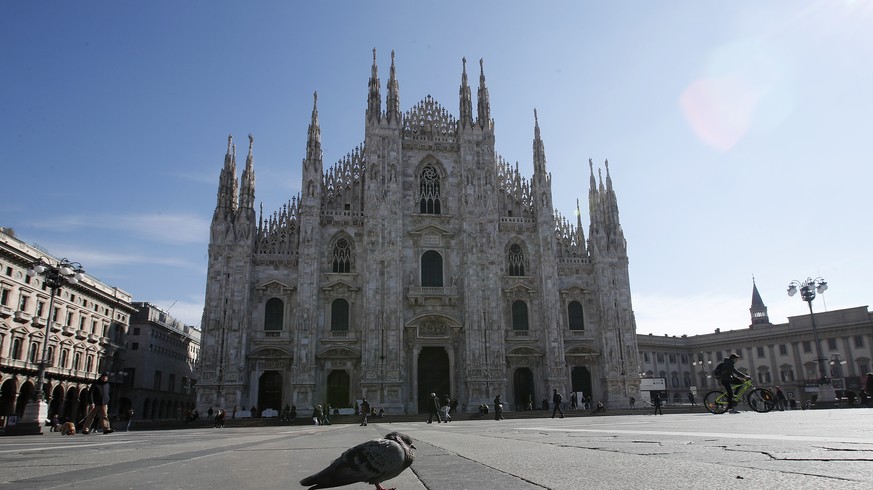 A pigeon stands in an almost empty Duomo cathedral square, in downtown Milan, Italy, Sunday, March 8, 2020. Italy announced a sweeping quarantine early Sunday for its northern regions, igniting travel ...