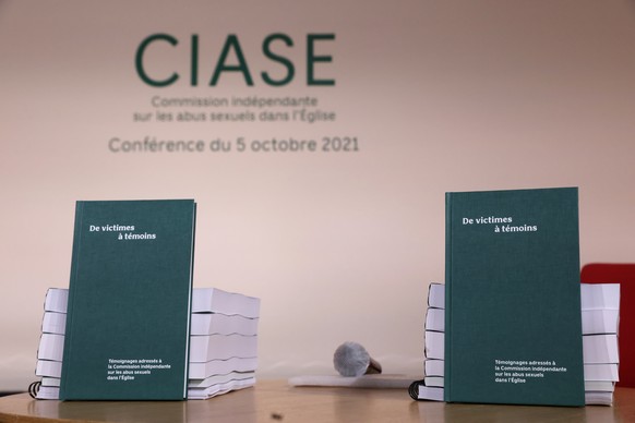 A picture shows copies of the report displayed on a table during the publishing of a report by an independant commission into sexual abuse by church officials (Ciase), Tuesday, Oct. 5, 2021, in Paris. ...