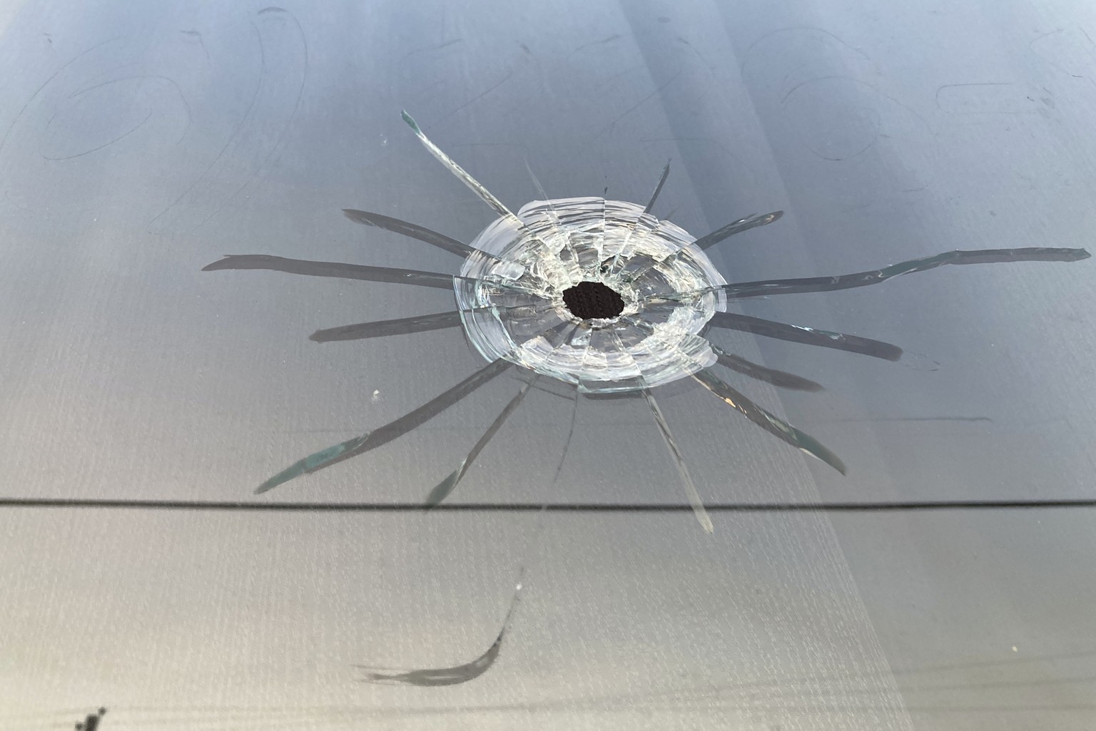 FILE - A bullet hole is visible in the glass transom over the door at the Mahogany Masterpiece dance studio in Dadeville, Ala., Sunday, April 16, 2023. Recent high-profile mass shootings highlight wha ...