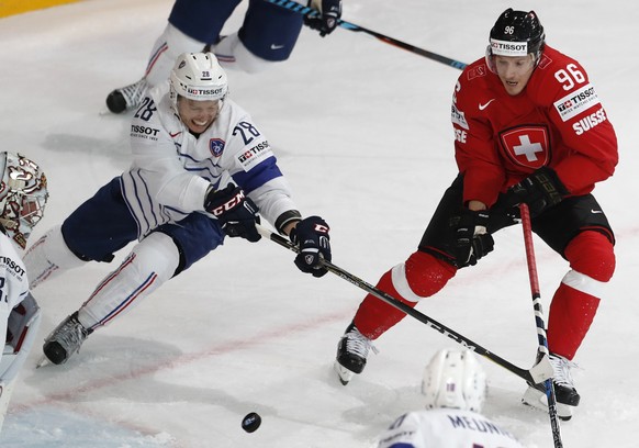 France&#039;s Damien Raux, left, challenges Switzerland&#039;s Damien Brunner, right, during the Ice Hockey World Championships group B match between Switzerland and France in the AccorHotels Arena in ...