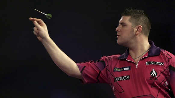 Britain&#039;s Daryl Gurney in action during the walk on during day ten of the World Darts Championship at Alexandra Palace, London, Saturday, Dec. 23, 2017. (Steven Paston/PA via AP)