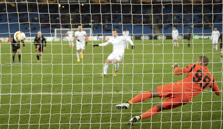 Basel&#039;s Fabian Frei, back center, scores against Apoel&#039;s goalkeeper Boy Waterman, right, during the UEFA Europa League round of 32 second leg soccer match between Switzerland&#039;s FC Basel ...