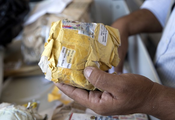epa06952407 Palestinian employees sort undelivered mail at the Palestinian central international exchange post office in the West Bank city of Jericho, 16 August 2018. Earlier on the same week Israel  ...