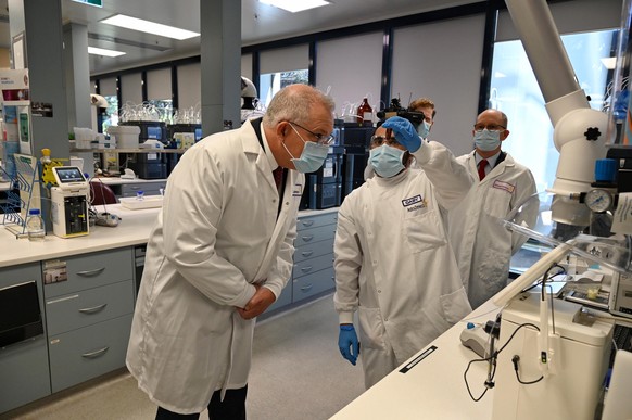 epa08611966 Australian Prime Minister Scott Morrison (L) tours the Astra Zeneca laboratories in Macquarie Park, Sydney, Australia, 19 August 2020. The Australian government has signed a deal with Astr ...