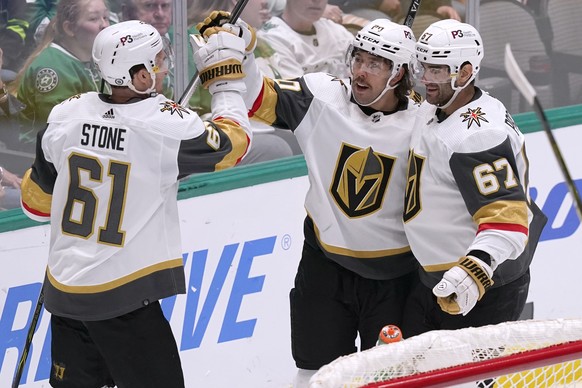 Vegas Golden Knights center Chandler Stephenson (20) celebrates his goal with Mark Stone (61) and Max Pacioretty (67) during the second period of an NHL hockey game against the Dallas Stars in Dallas, ...