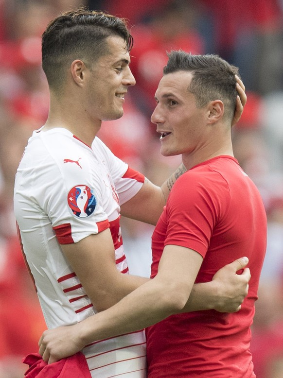 Swiss midfielder Granit Xhaka, left, cheers with his brother Albania's midfielder Taulant Xhaka, right, after the UEFA EURO 2016 group A preliminary round soccer match between Albania and Switzerland, ...