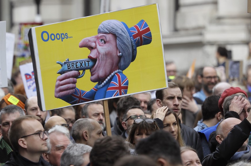 A poster depicting British Prime Minister Theresa May is carried among demonstrators during a Peoples Vote anti-Brexit march in London, Saturday, March 23, 2019. The march, organized by the People&#03 ...