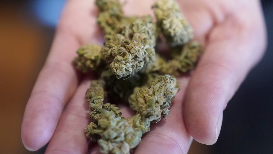 Budtender Taylor Altshule holds Cherry Pie marijuana at a California Street Cannabis Company location in San Francisco Monday, March 20, 2023. Twitter under its 420-friendly owner Elon Musk has previously…