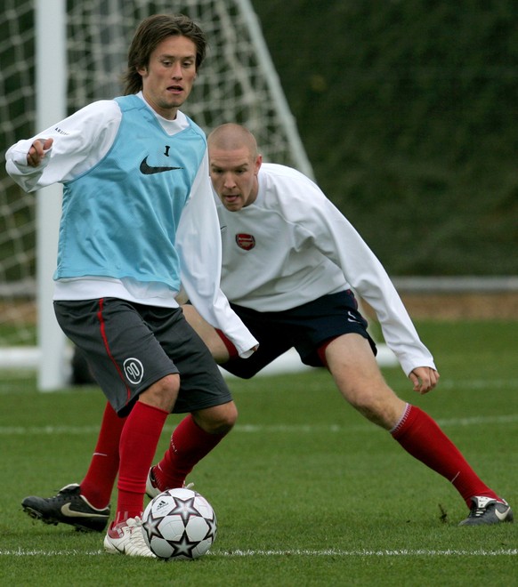 Arsenal's midfielder Tomas Rosicky, left, shields the ball from teammate Philippe Senderos during a training session at the club's training facilities in Colney, north London, Tuesday Oct. 3 ...