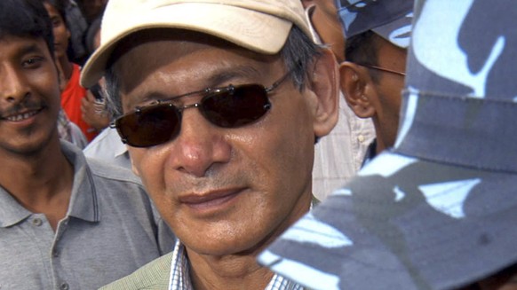 FILE - Police escort convicted French serial killer Charles Sobhraj from court in Katmandu, Nepal on Aug. 12, 2004. Confessed serial killer Sobhraj, who was convicted and sentenced to life in prison i ...