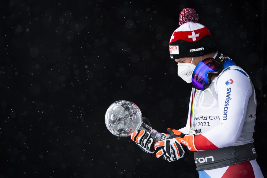epa09079589 Beat Feuz of Switzerland celebrates with the crystal globe of the overall men&#039;s Downhill competition during the podium ceremony at the FIS Alpine Skiing World Cup finals, in Lenzerhei ...
