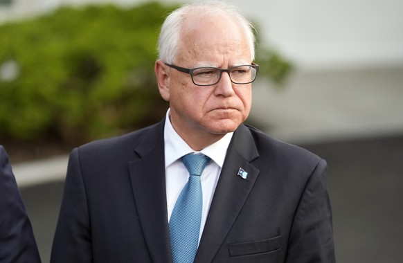 FILE - Minnesota Gov. Tim Walz listens after meeting with President Joe Biden, July 3, 2024, at the White House in Washington. A trademark lawyer who bought the domain named ClintonKaine.com in 2016 i ...