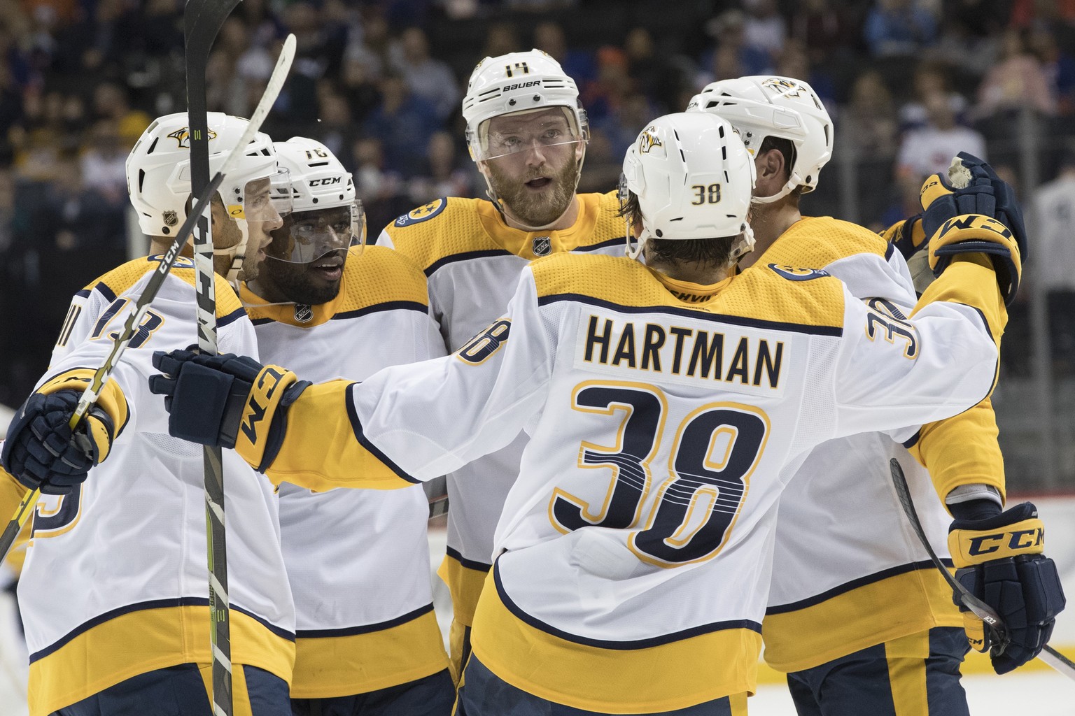 Nashville Predators defenseman Mattias Ekholm, center, celebrates scoring a goal with his team mates during the first period of an NHL hockey game against the New York Islanders, Saturday, Oct. 6, 201 ...