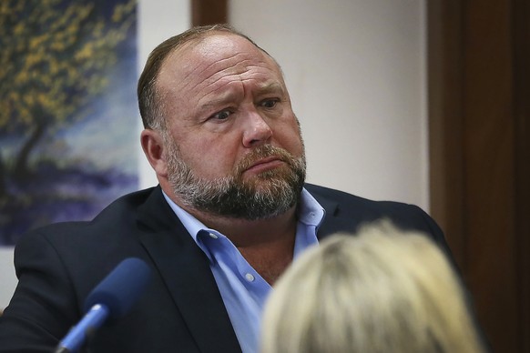 FILE - In this Aug 3, 2022 file photo, conspiracy theorist Alex Jones attempts to answer questions about his emails during trial at the Travis County Courthouse in Austin. An attorney representing two ...