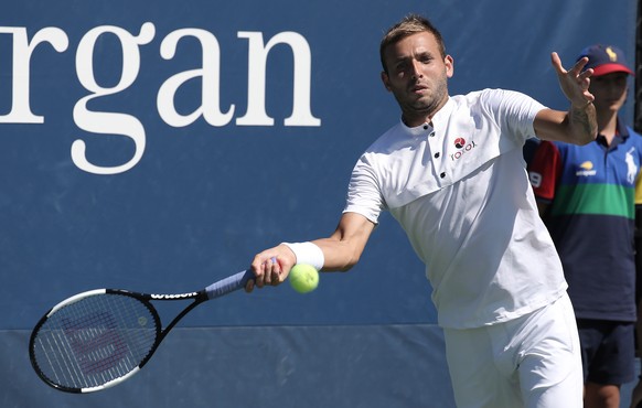 epa07801662 Daniel Evans of Great Britain hits a return to Lucas Pouille of France during their match on the fourth day of the US Open Tennis Championships the USTA National Tennis Center in Flushing  ...