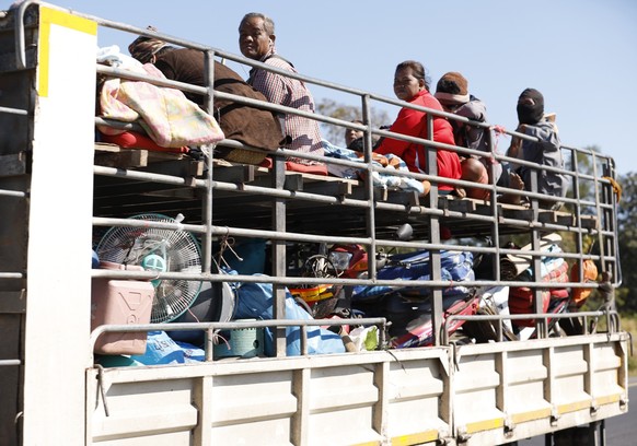 epa12586904 Displaced Thai villagers, carrying their belongings, travel on a truck as they evacuate during clashes between Thai and Cambodian troops in Si Sa Ket province, Thailand, 12 December 2025.  ...
