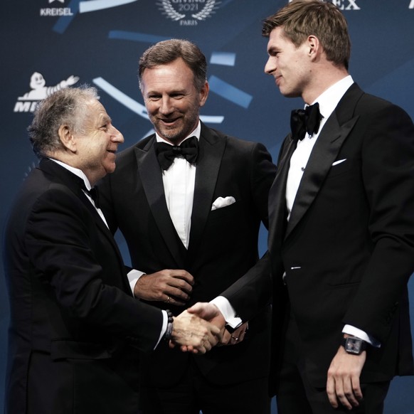 FIA President Jean Todt, left, shakes hands with Formula One world champion Max Verstappen of the Netherlands, right, as Red Bull team chief Christian Horner looks on as they leave a press conference  ...