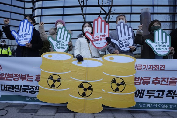 Environmental activists stage a rally demanding the withdrawal of Japanese government&#039;s decision to release treated radioactive water from the Fukushima Daiichi nuclear power plant, near a buildi ...